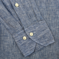 A close-up of the Mid Blue Linen Cutaway Slimline Shirt by Stenströms features a textured blue sleeve with cream buttons on the cuff, highlighting its Slimline fit as a summer essential.