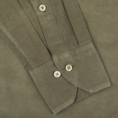 Close-up of the cuffs of the Stenströms Moss Green Cotton Corduroy Slimline Shirt with buttoned closures, highlighting its Slimline design against a fabric background.