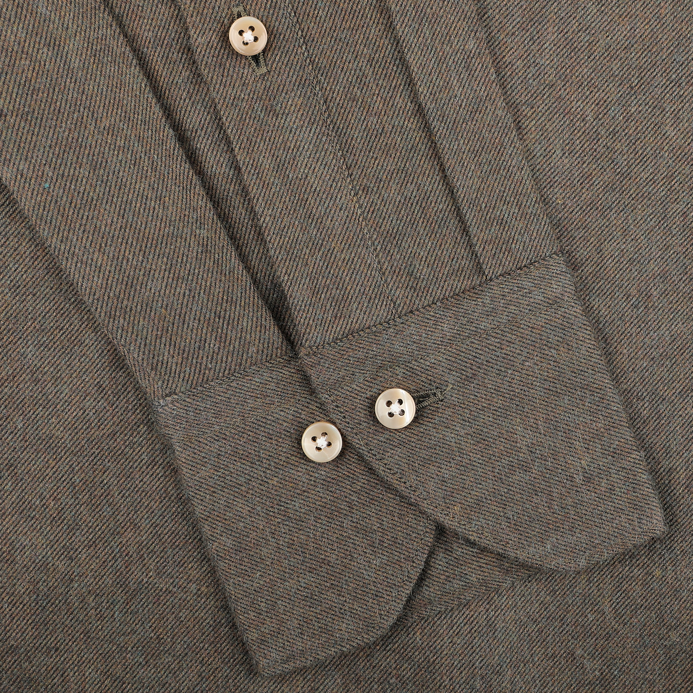 Close-up of a moss green cotton flannel shirt with buttoned cuffs, showcasing a cut-away slimline design for a tailored fit by Stenströms.