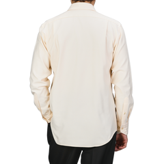 Rear view of a person wearing the Off-White Cotton Flannel Fitted Body Shirt by Stenströms with mother-of-pearl buttons, paired with dark pants against a neutral background.