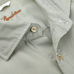 Close-up of a Stenströms pale green contemporary slimline lyocell shirt collar, adorned with tan buttons and an embroidered brand name.