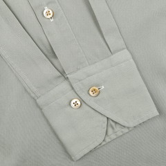 The Pale Green Lyocell Slimline Shirt by Stenströms features a close-up of the light gray cuff with two beige buttons and a diagonal buttoned placket, embodying modernity that complements its contemporary design.