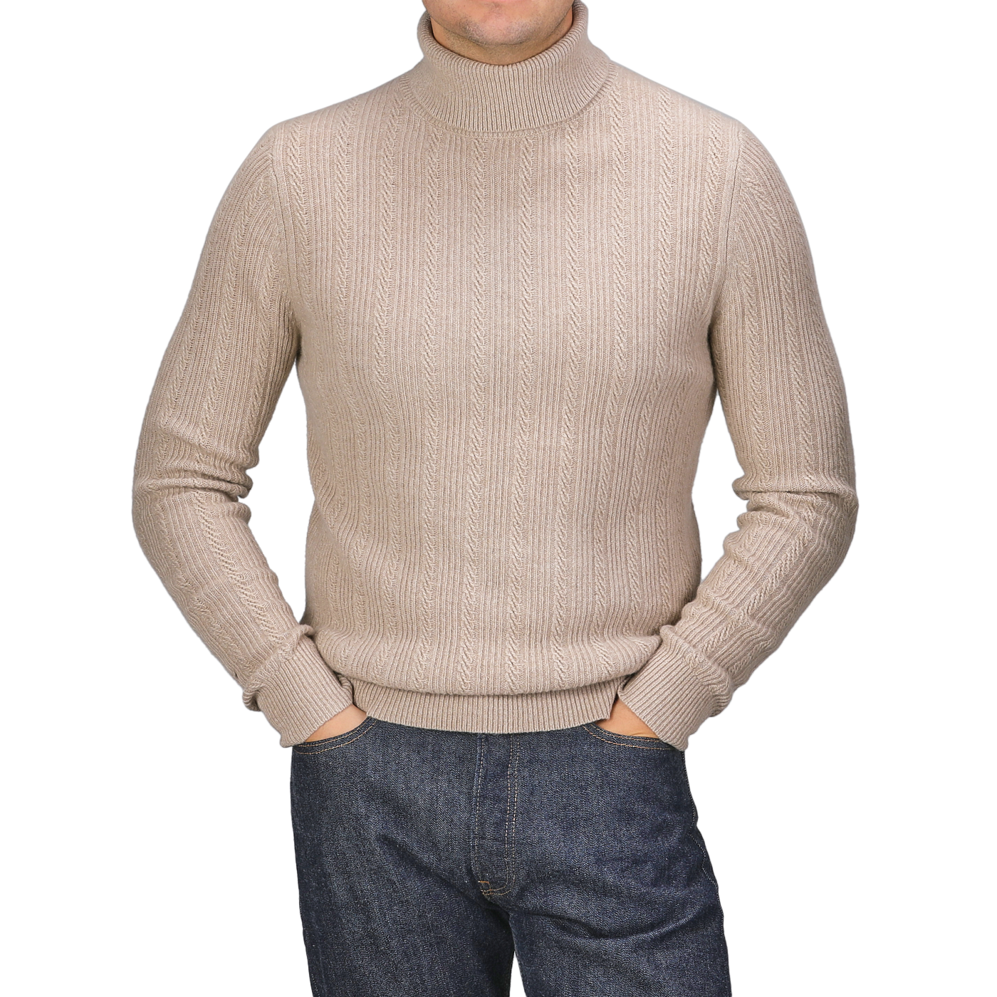 Person wearing a Taupe Beige Structured Merino Rollneck by Stenströms and dark jeans with hands in pockets, standing against a plain background.