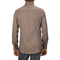 Back view of a person wearing a Taupe Brown Cotton Flannel Slimline BD Shirt by Stenströms and dark pants, standing against a plain background.