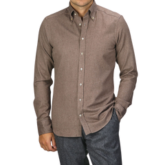 A person wearing a Taupe Brown Cotton Flannel Slimline BD Shirt by Stenströms and dark gray pants stands with one hand in their pocket.