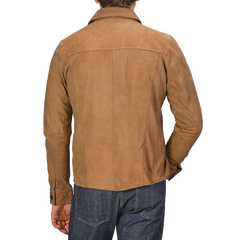 A person is seen from the back wearing a Tobacco Brown Lamb Suede Overshirt from Stenströms, paired with regular-fit jeans.