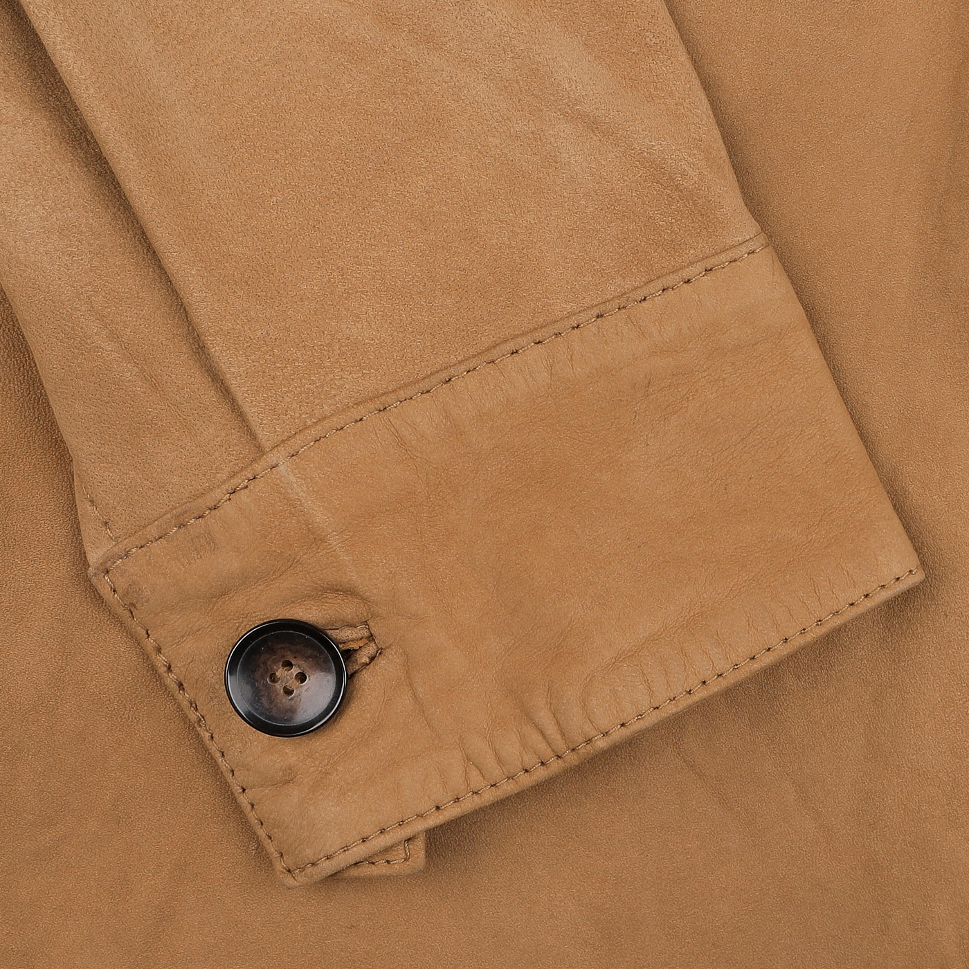 Close-up of the sleeve from the regular fit Tobacco Brown Lamb Suede Overshirt by Stenströms, showcasing a luxurious lambskin material with a dark brown button and visible stitching.