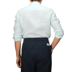 From behind, the individual sports a Stenströms Turquoise Linen Cutaway Slimline Shirt, ideal for summer essentials, paired with dark pants.