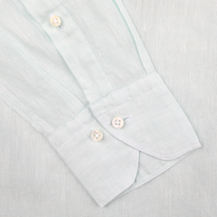 Close-up of Stenströms' Turquoise Linen Cutaway Slimline Shirt cuff with two white buttons on a matching fabric, highlighting its summer essential charm.