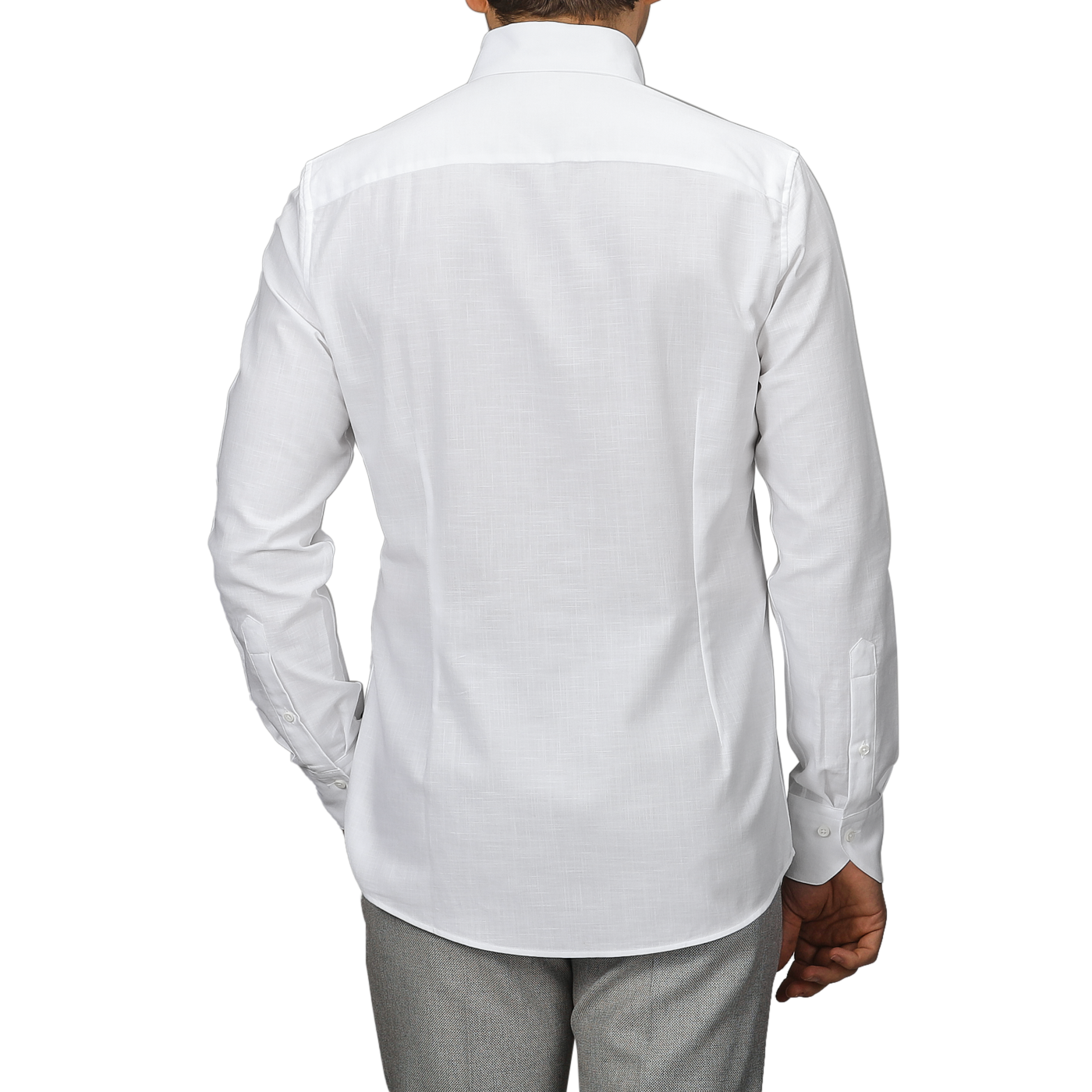 Rear view of a person in a Stenströms White Soft Cotton BD Slimline Shirt paired with gray pants against a plain background.