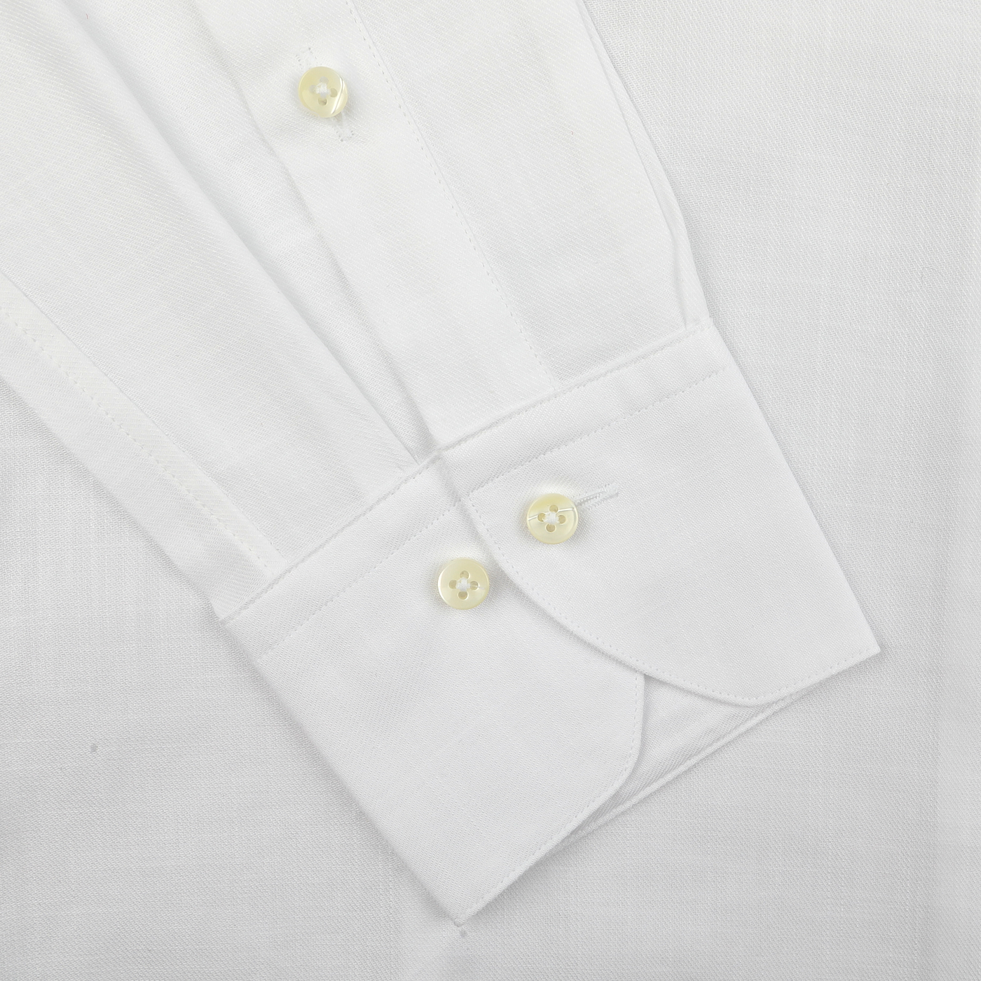 Close-up of the Stenströms White Soft Cotton BD Slimline Shirt, showcasing its button-down collar, slim fit design, and cuffs with buttons against a textured fabric background.