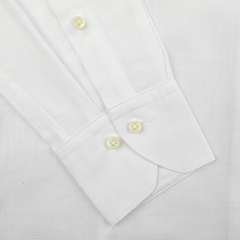 Close-up of the Stenströms White Soft Cotton BD Slimline Shirt, showcasing its button-down collar, slim fit design, and cuffs with buttons against a textured fabric background.