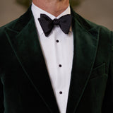 A man in a green velvet tuxedo with a black bow tie, wearing a Stenströms White Textured Cotton Slimline Tuxedo Shirt.