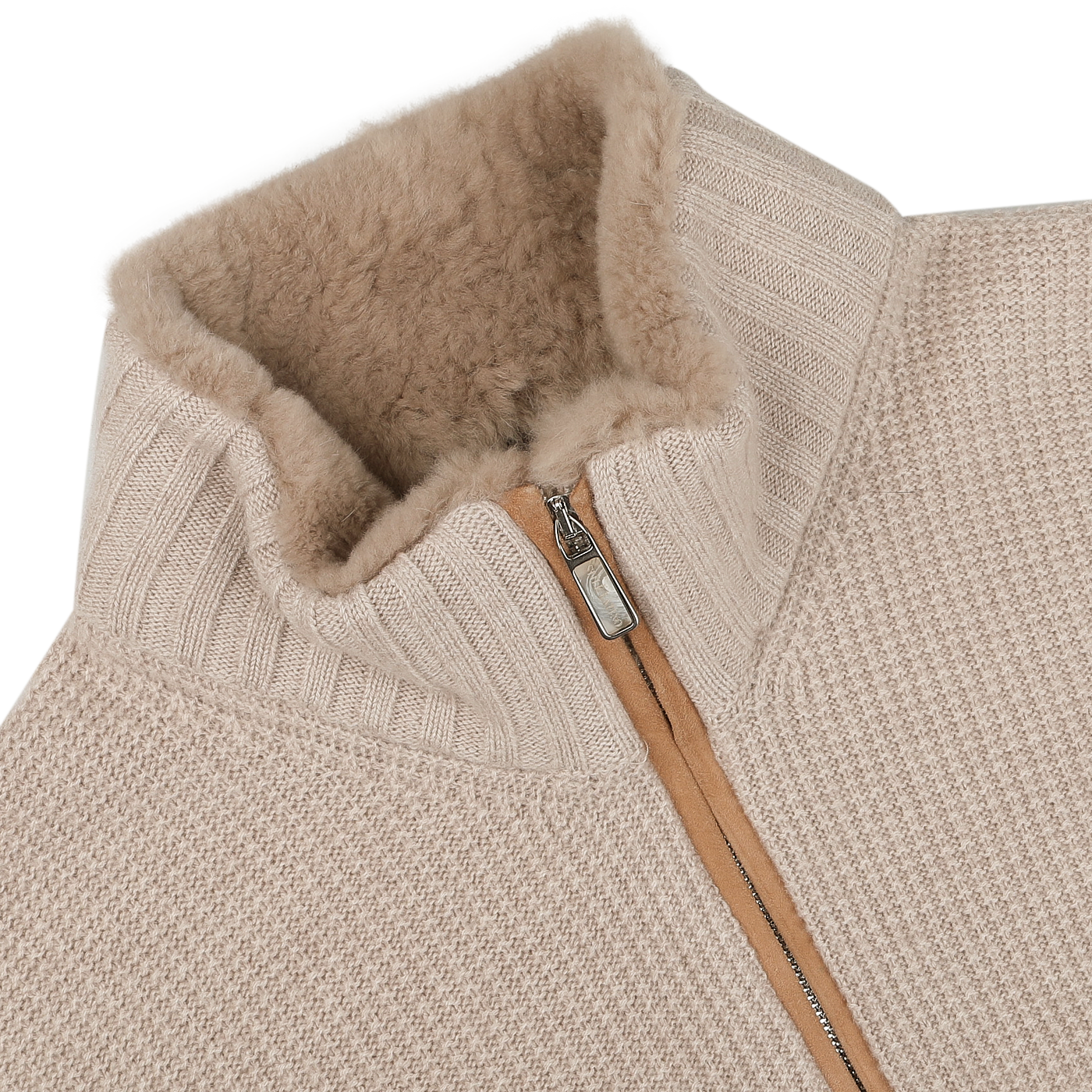 A close-up of the Light Beige Cashmere Fur Collar Cardigan from Stile Latino highlights its resemblance to a cashmere cardigan. The cozy, textured collar and partially unzipped zipper reveal the soft lining inside. The fabric showcases a ribbed and woven pattern, reflecting the elegance typical of luxury brands like Stile Latino.