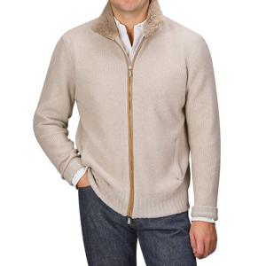 A person wearing the Light Beige Cashmere Fur Collar Cardigan from Stile Latino over a white shirt and dark jeans effortlessly exudes the elegance of a luxury brand.