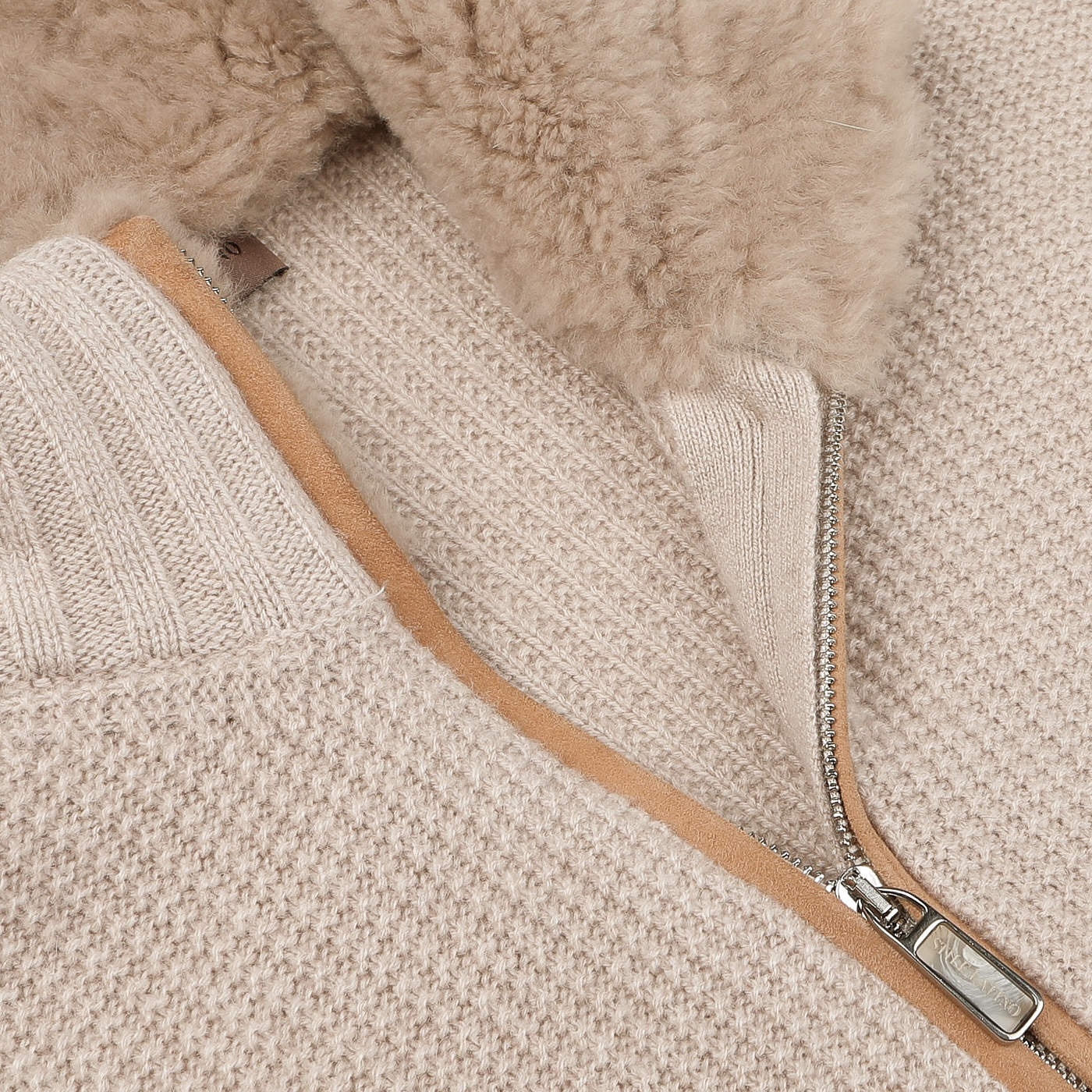 A detailed view of the Light Beige Cashmere Fur Collar Cardigan by Stile Latino, showcasing a partially open zipper that reveals its luxurious plush lining, exemplifying the brand's high-quality craftsmanship.