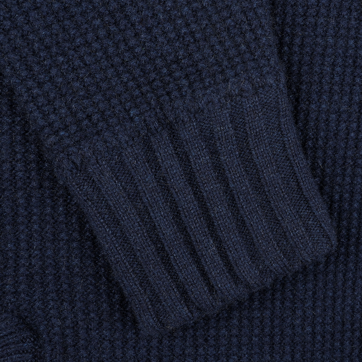 Close-up of a sleeve featuring a ribbed cuff from the Royal Blue Cashmere Fur Collar Cardigan by Stile Latino, showcasing its soft cashmere fibers.