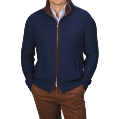 A person is dressed in a Royal Blue Cashmere Fur Collar Cardigan from Stile Latino, worn over a blue collared shirt and brown pants. This cardigan showcases cashmere fibers with a distinguished brown fur collar, radiating refined elegance.