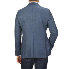 A person wearing Studio 73's Blue Houndstooth Wool Flannel Blazer and dark jeans is shown from the back against a plain background.