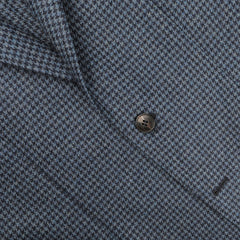 Close-up of a dark blue houndstooth patterned fabric from the Studio 73 Blue Houndstooth Wool Flannel Blazer with a single black button in the center.