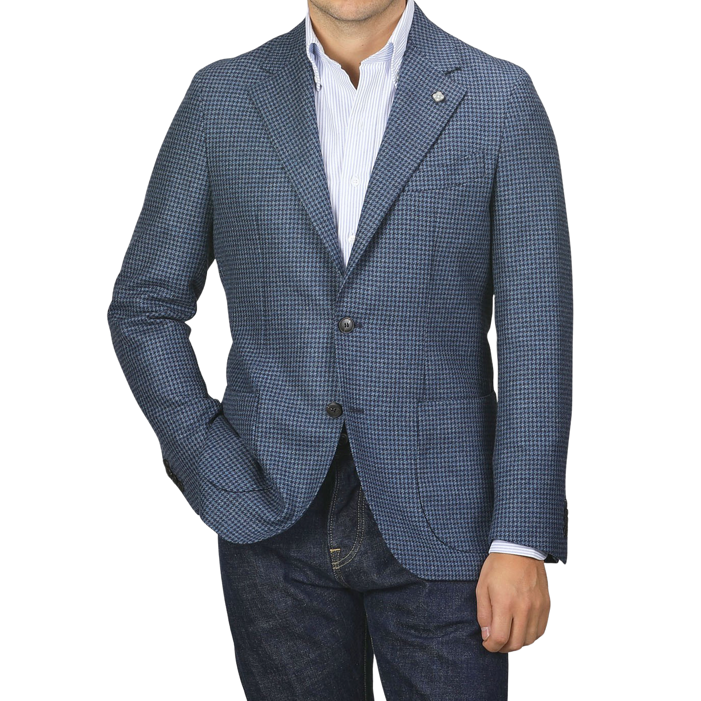 Man wearing a Blue Houndstooth Wool Flannel Blazer by Studio 73 over a white striped shirt and dark jeans, with hands in his pockets against a plain background.