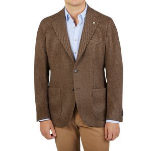 A man wearing a brown Houndstooth Wool Cashmere Blazer by Studio 73 and tan pants.