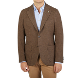 A man wearing a brown Houndstooth Wool Cashmere Blazer by Studio 73 and tan pants.