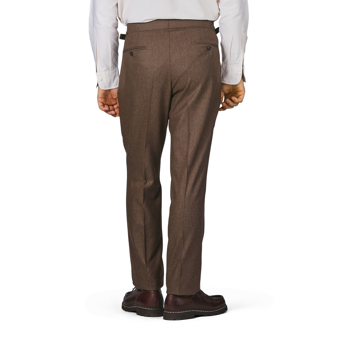 A person wearing high-waist Studio 73 Brown Melange Wool Flannel Pleated Trousers, a white long-sleeve shirt, and dark brown shoes stands with their back to the camera.