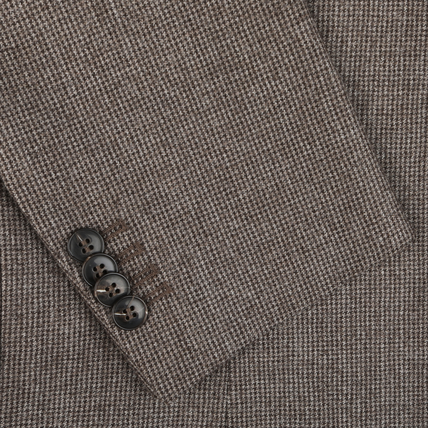 Close-up of the Brown Micro-Houndstooth Wool Flannel Suit sleeve by Studio 73, showcasing the pure wool fabric with four dark buttons on the cuff.