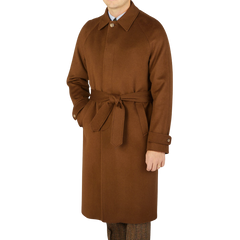 A contemporary man with a Studio 73 twist, confidently sporting a Dark Brown Camel Wool Cashmere Raglan Coat.