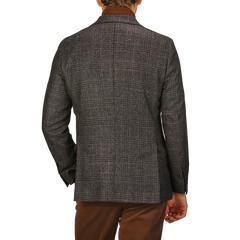 The individual is wearing a fashionable Dark Brown Checked Wool Cashmere Blazer by Studio 73 and brown pants, photographed from the back against a plain background.