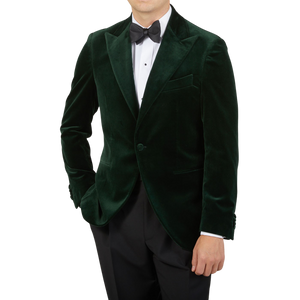 A man in a Dark Green Cotton Velvet Dinner Jacket by Studio 73 exuding a formal look.