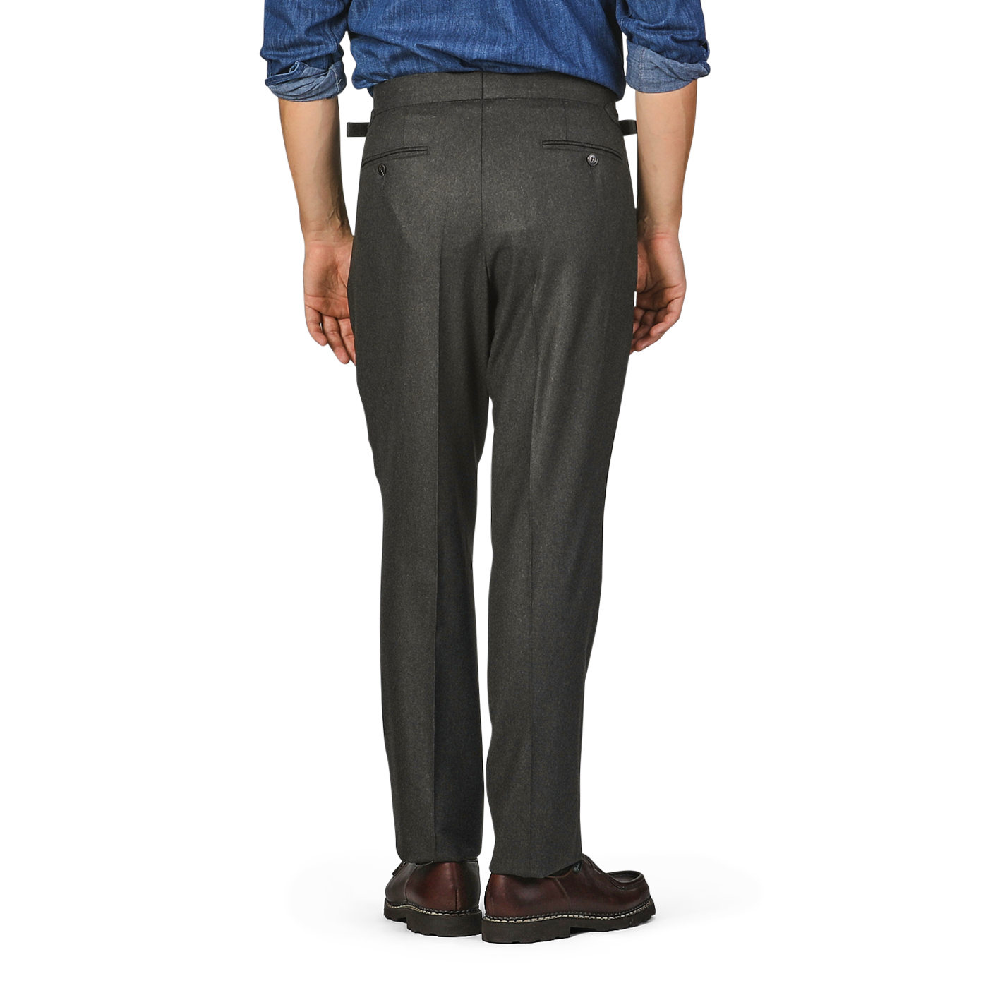 A person standing with their back facing the camera, wearing Studio 73 Dark Green Wool Flannel Pleated Trousers, a blue shirt, and brown shoes.