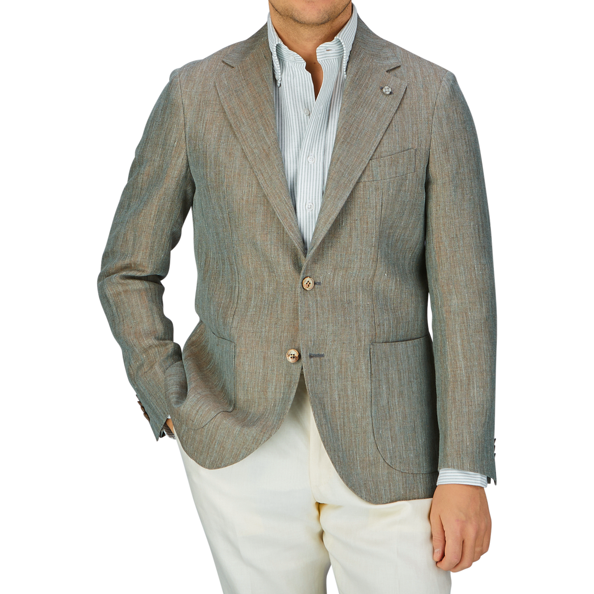 A man wearing a Green Melange Herringbone Linen Blazer from Studio 73, striped shirt, and white pants.