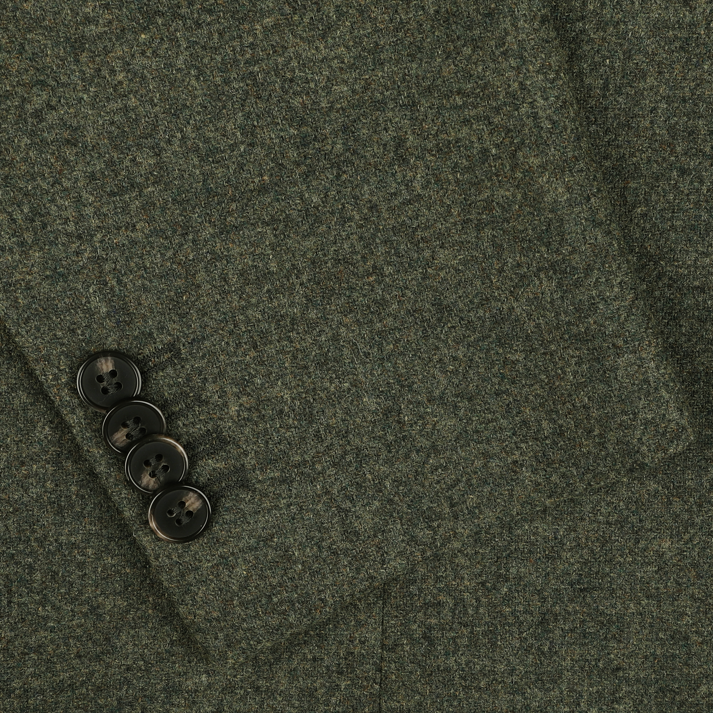 Close-up of the sleeve of the Studio 73 Green Melange Wool Tweed Blazer, showcasing four dark buttons that embody its contemporary charm.