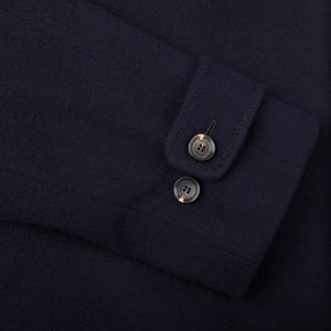 A close up of a Studio 73 navy wool-cashmere blend raglan coat with buttons.