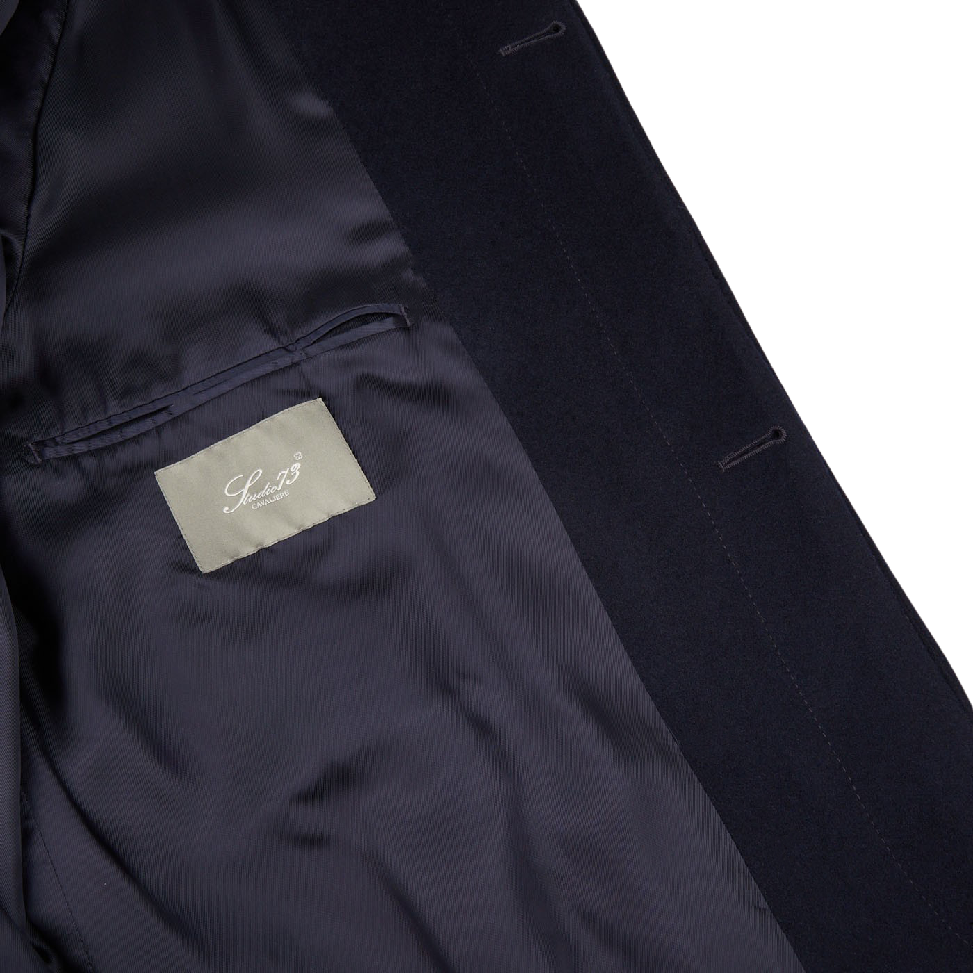 The back of a Navy Wool Cashmere Raglan Coat with a Studio 73 label on it.