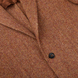 A close up of a Studio 73 Orange Herringbone Wool Tweed Blazer.