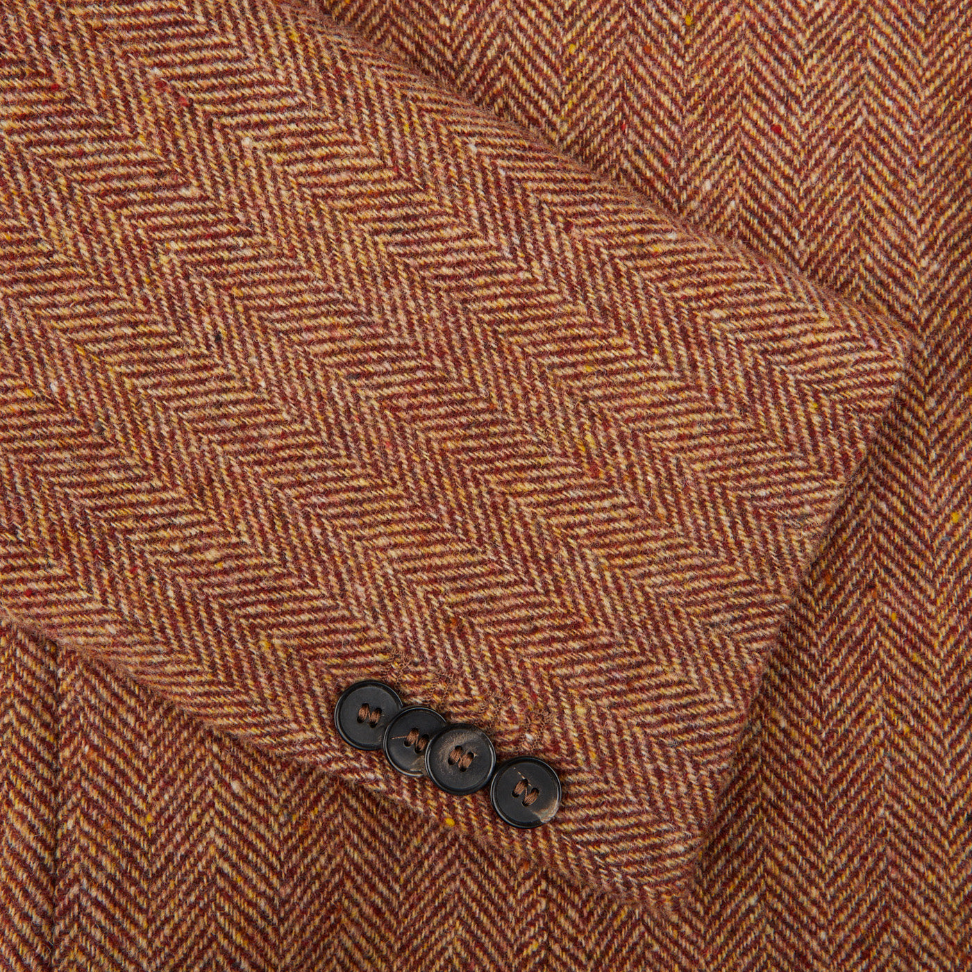 A close up of an Orange Herringbone Wool Tweed Blazer made by Studio 73.