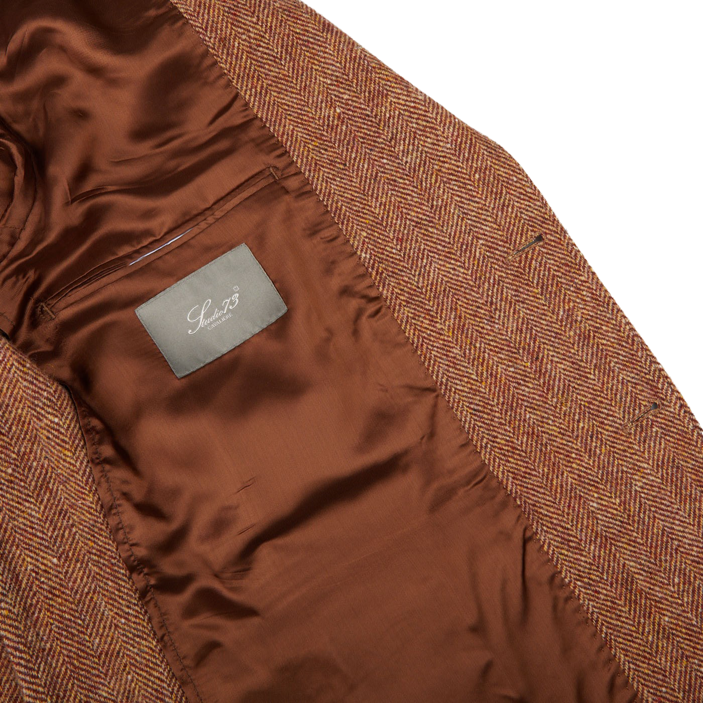 A Studio 73 Orange Herringbone Wool Tweed Blazer with a label on it.