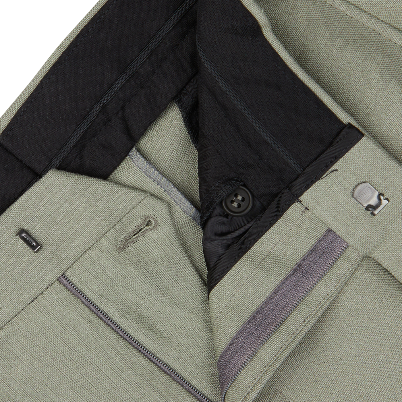 Close-up view of a Sage Green Canapa Hemp DB Suit showing the inside waistline, zipper, button, and fasteners by Studio 73.