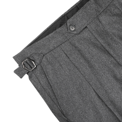 Close-up of the Studio 73 Dark Grey Wool Flannel Pleated Trousers, showcasing a high-waist tapered leg with a buckle detail and button closure at the waistband.