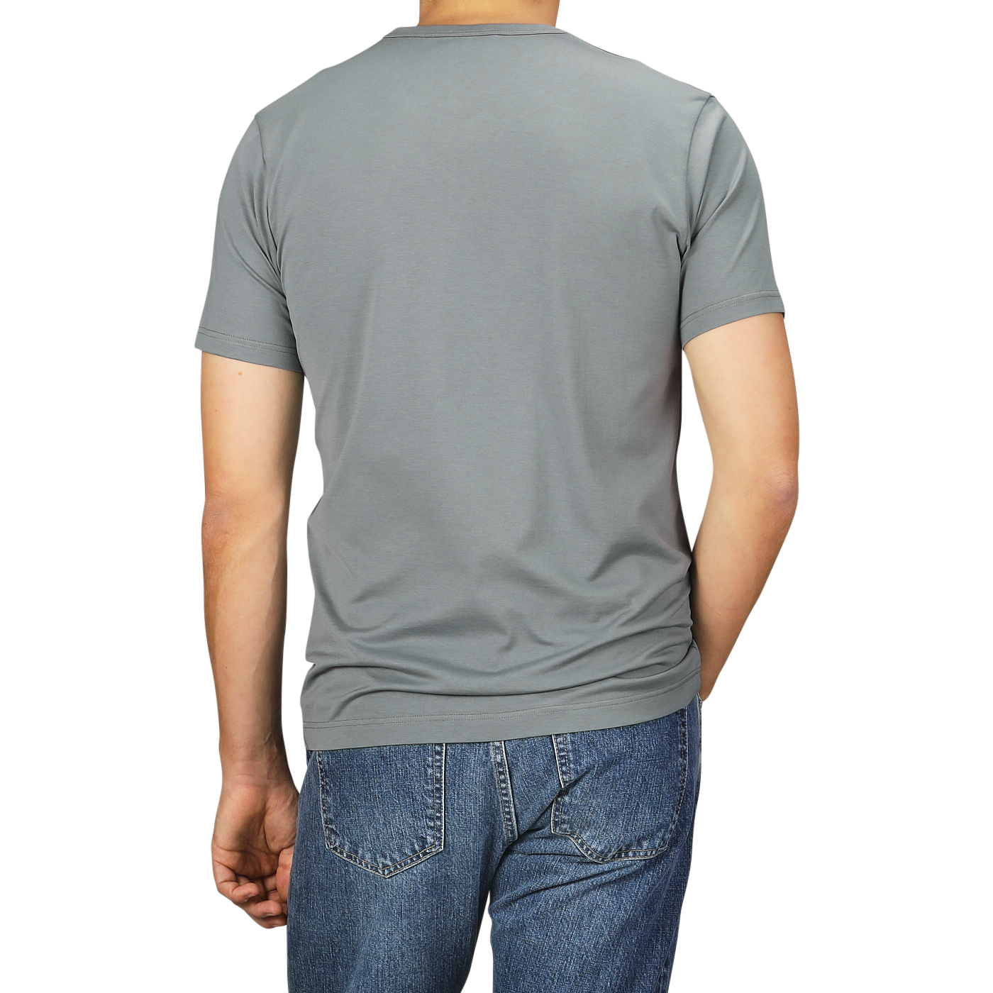 A person wearing a Smoke Green Classic Cotton T-Shirt by Sunspel and blue jeans is shown from the back.