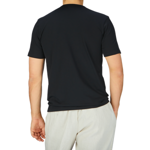 The man is wearing a Sunspel Black Classic Cotton T-Shirt.