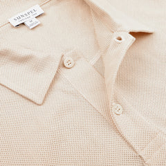 The Ecru Beige Cotton Riviera Polo Shirt by Sunspel is crafted from breathable cotton mesh, featuring button details and the distinctive Sunspel brand label.