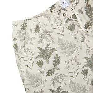 A pair of Sunspel Ecru Katie Scott Drawstring Swim Shorts with a green and white print.