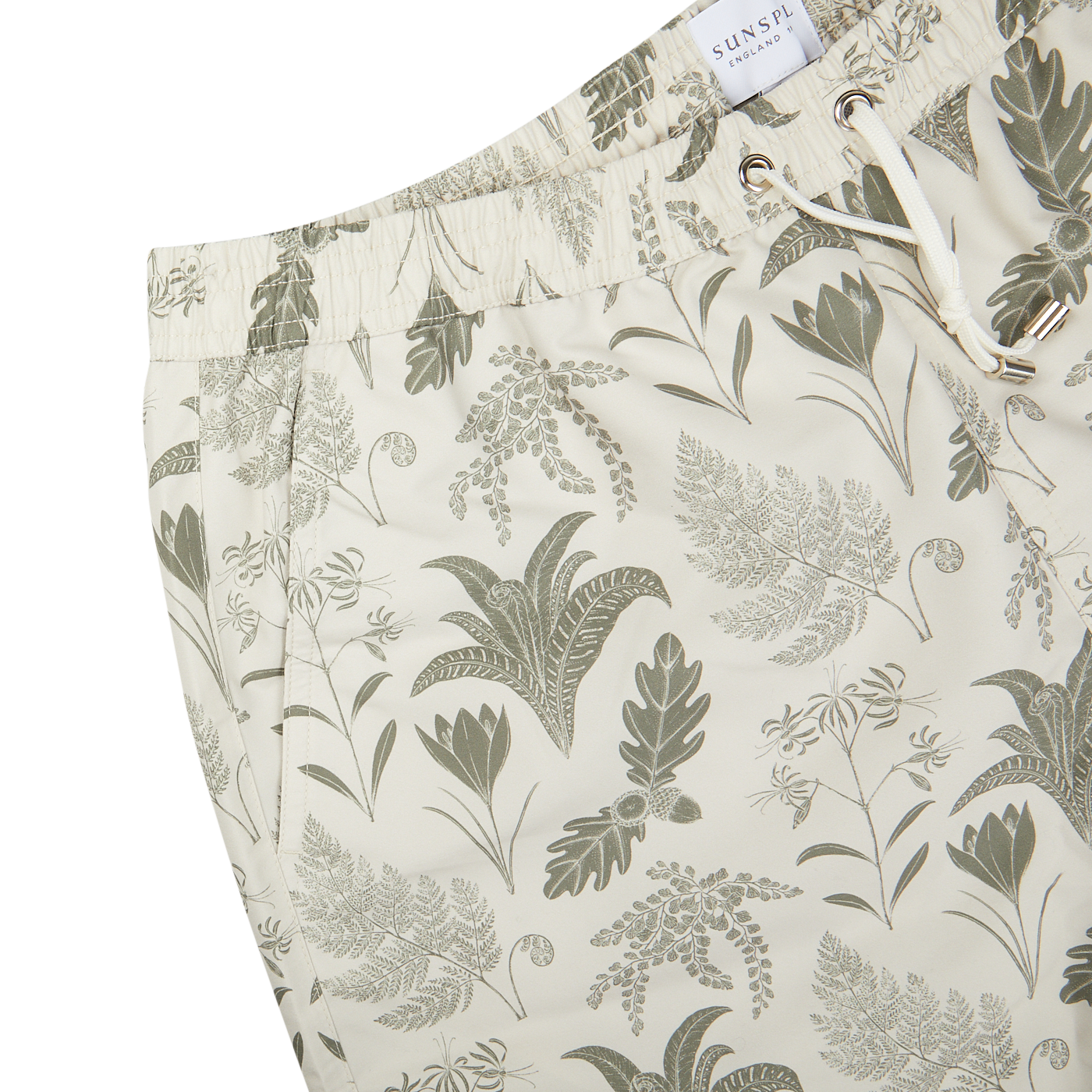 A pair of Sunspel Ecru Katie Scott Drawstring Swim Shorts with a green and white print.