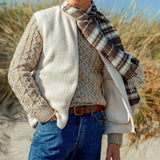 A man wearing a Sunspel Ecru Wool Fleece Gilet and jeans.