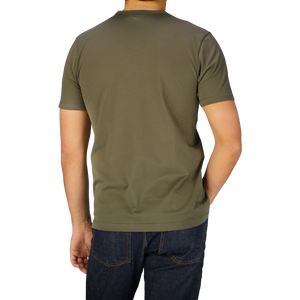 A man wearing a Khaki Green Classic Cotton T-shirt by Sunspel.