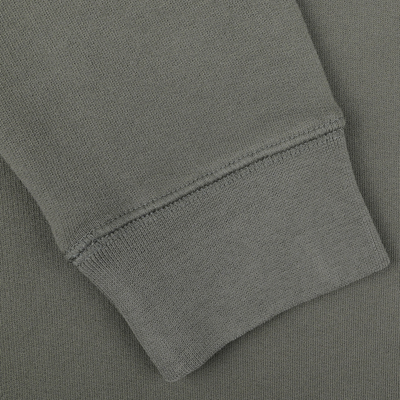 Close-up of a Khaki Green Cotton Loopback Sweatshirt sleeve by Sunspel, featuring a ribbed cuff that highlights the luxurious cotton loopback fabric and intricate stitching details.